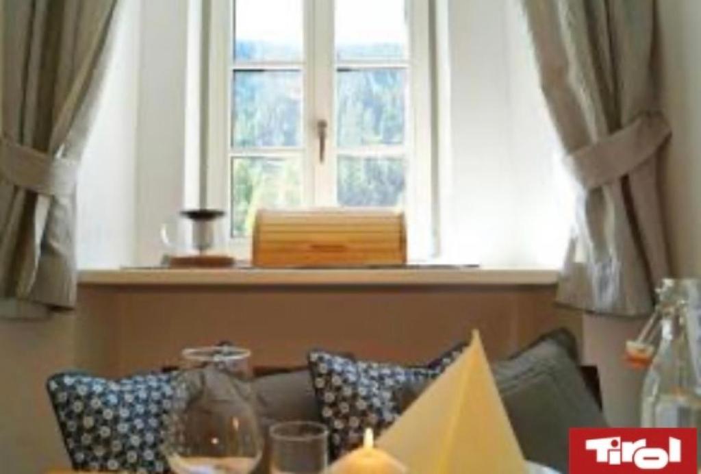a living room with a couch and a window at Priestereck in Obernberg am Brenner