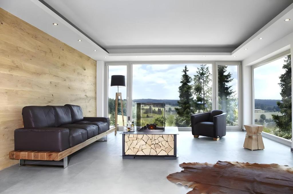 a living room with a leather couch and a table at Panorama in Ibach