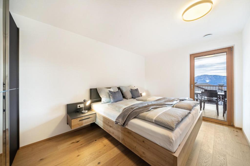 a bedroom with a large bed and a window at Apartment Klara in Meltina