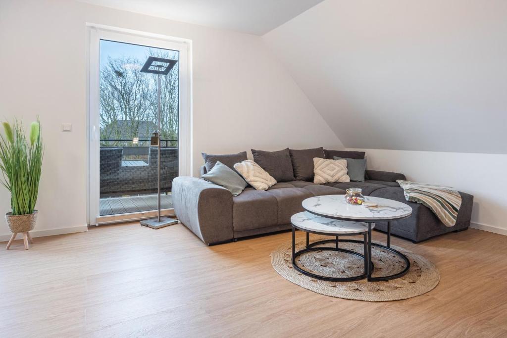 a living room with a couch and a table at Kroge Apartment in Uelzen