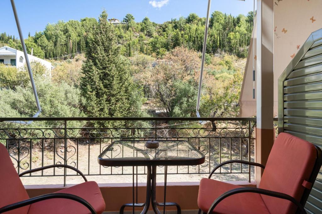 a balcony with a table and chairs and a view at Nontas Homes 36 in Kalamitsi