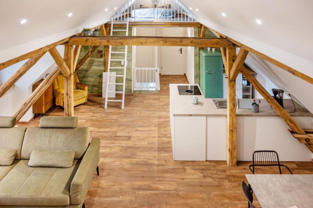a loft conversions kitchen and living room with wooden beams at Schwalbenloft in Wagenfeld