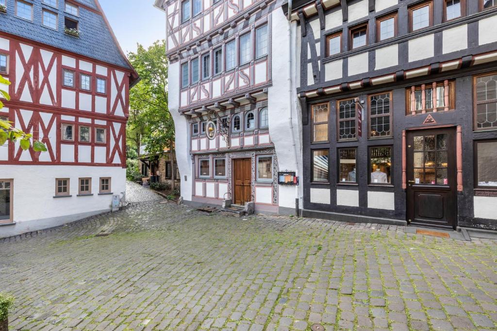 a cobblestone street in the middle of two buildings at Werner-Senger-Haus Limburg in Limburg an der Lahn