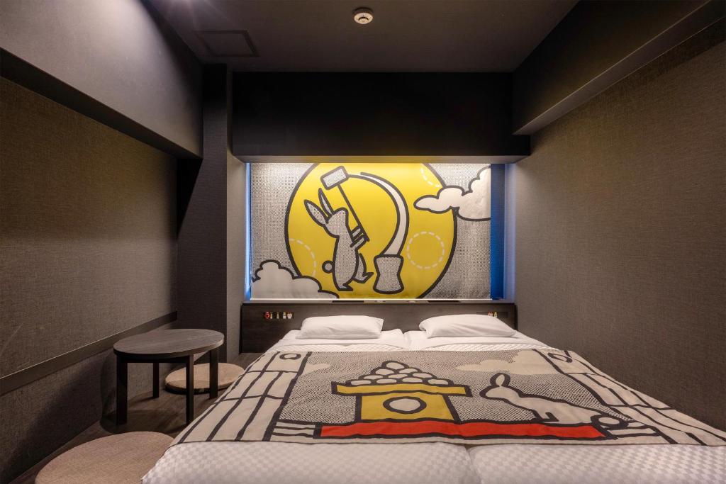 a bedroom with a bed with a painting on the wall at HOTEL TAVINOS Kyoto in Kyoto