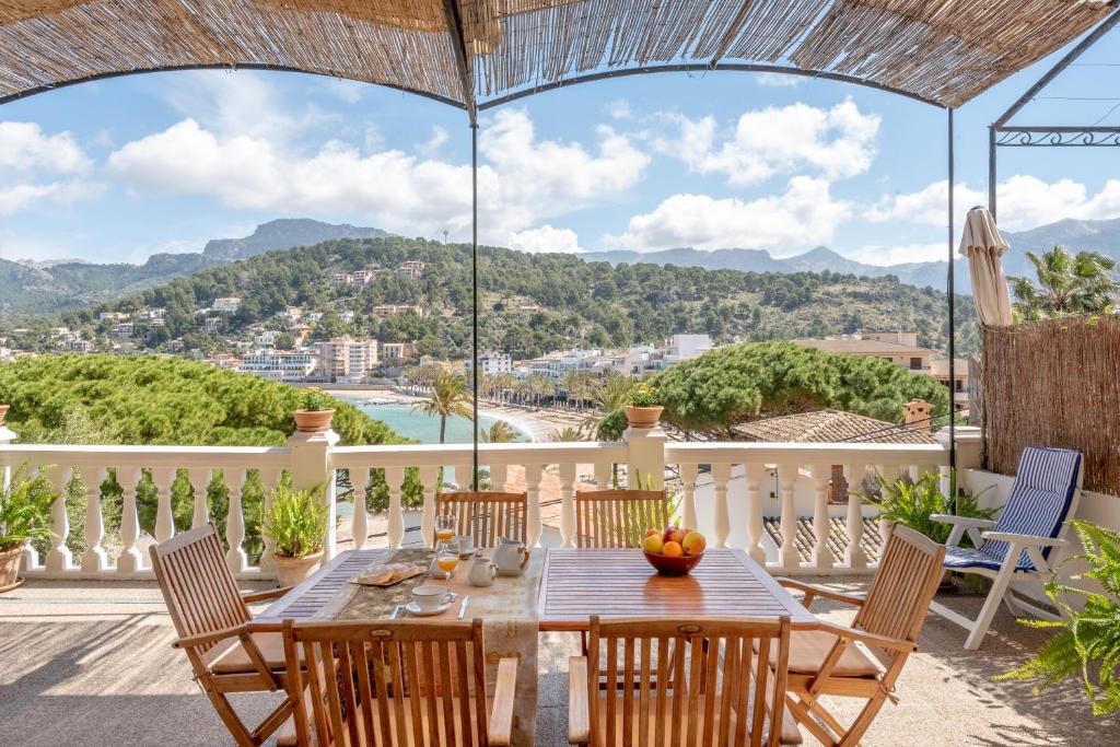 a dining room with a table and chairs on a balcony at Can Joi in Sóller