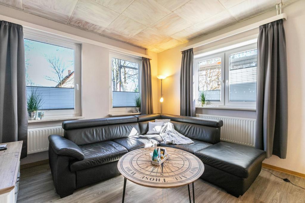 a living room with a couch and a table at Ferienhaus von Osten in Burg
