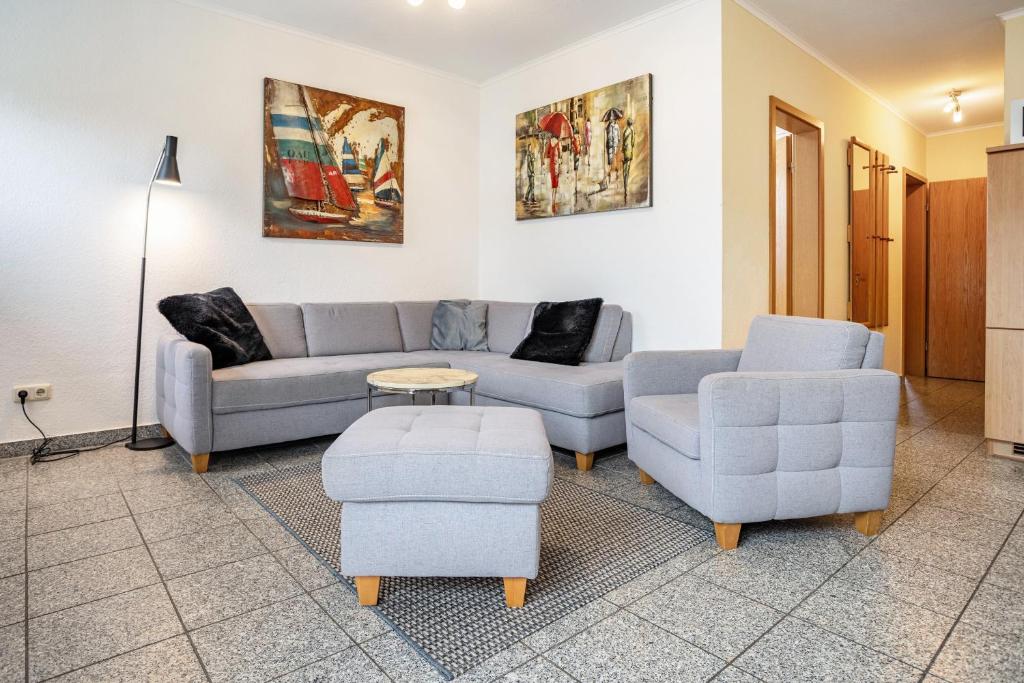 a living room with two couches and a table at Haus Frohsinn - Wohnung 3 in Binz