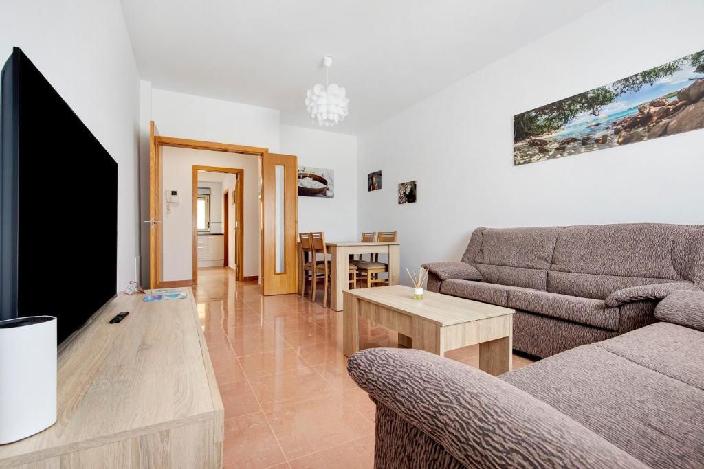 a living room with two couches and a flat screen tv at Casa Rosi 1 in Puerto del Rosario