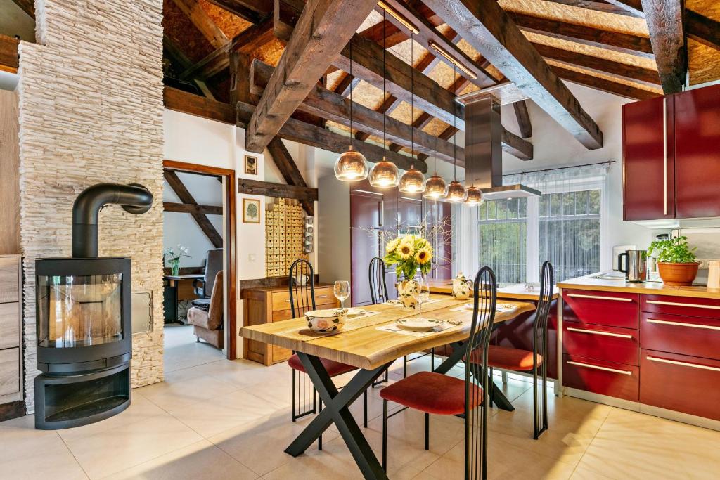 a kitchen with a wooden table and a stove at Wohnung am Stadtrand im Grünen in Zeuthen