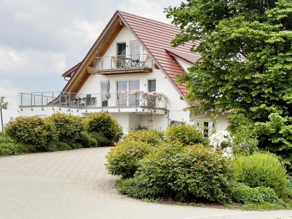 a white house with a red roof at Biohof Stotz in Friedrichshafen