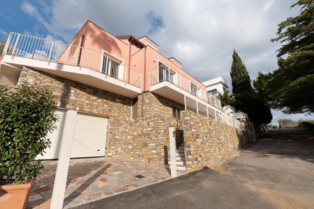a large brick house with a white garage at Saint Claude in Marina di Andora