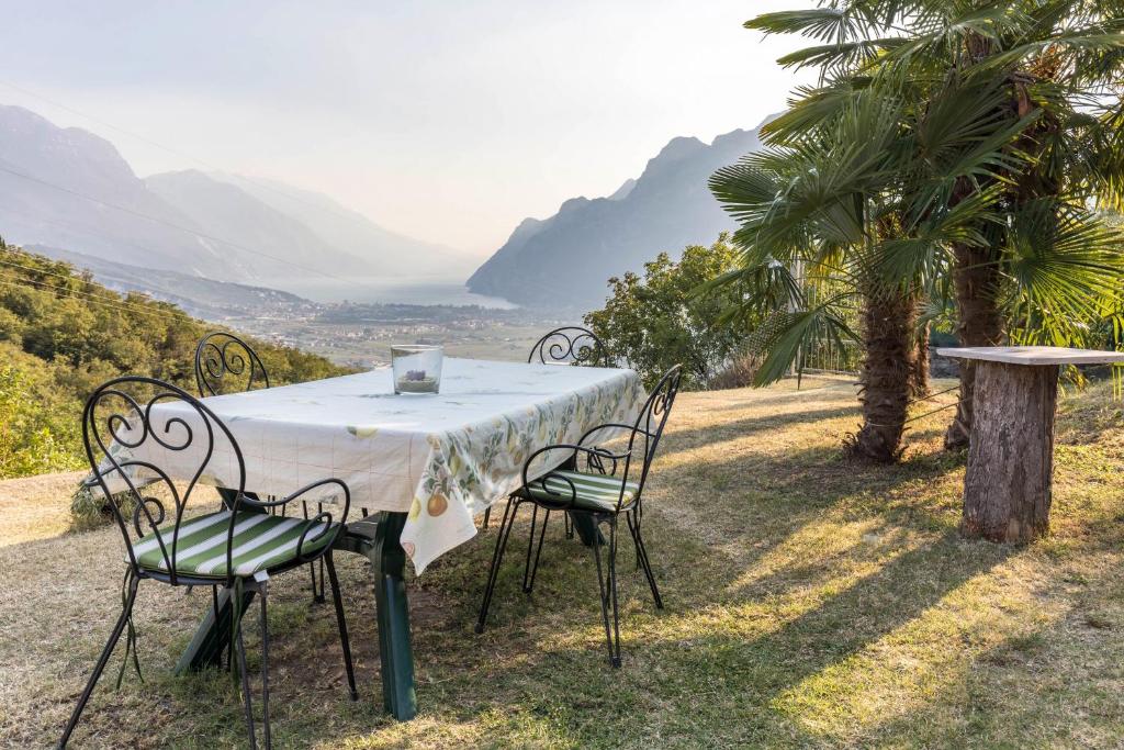 a table and chairs with a view of the mountains at Casa Zanoni in Arco