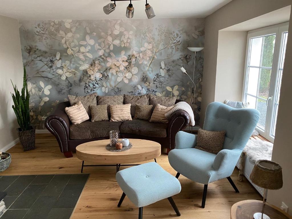 a living room with a couch and a table and chairs at Ferienhaus auffm Hebberg in Attendorn