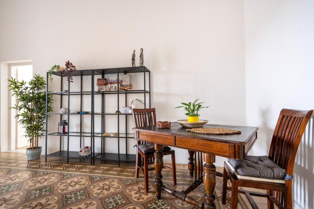 a dining room with a table and two chairs at Exclusive Maison Valentina in Monopoli