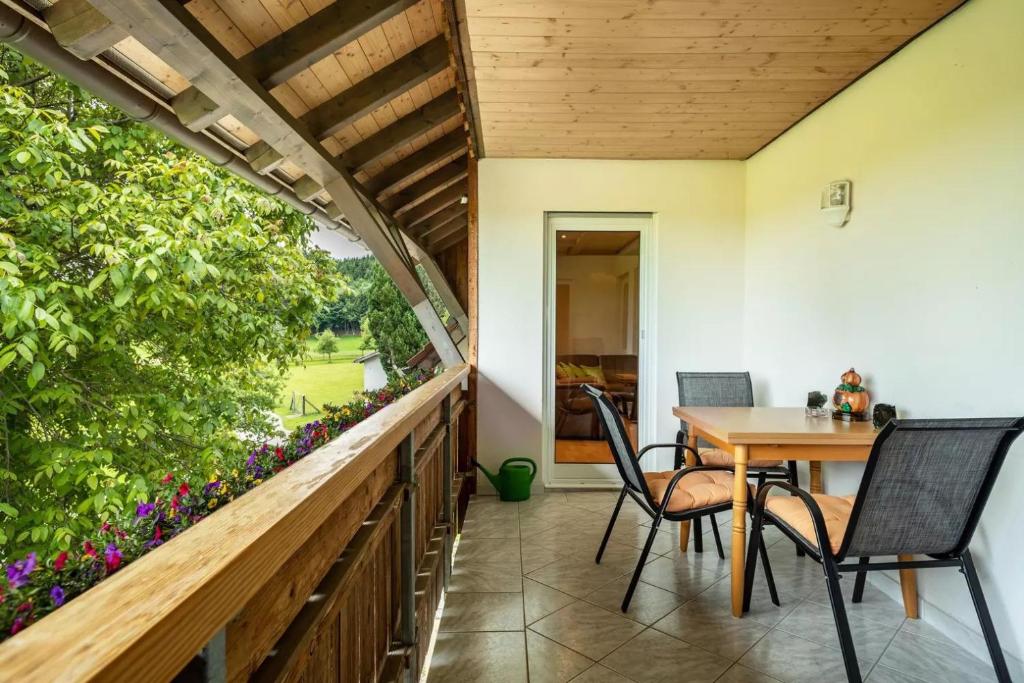 a patio with a table and chairs on a balcony at Urlaub auf dem Hirschhof Stehle in Waldburg