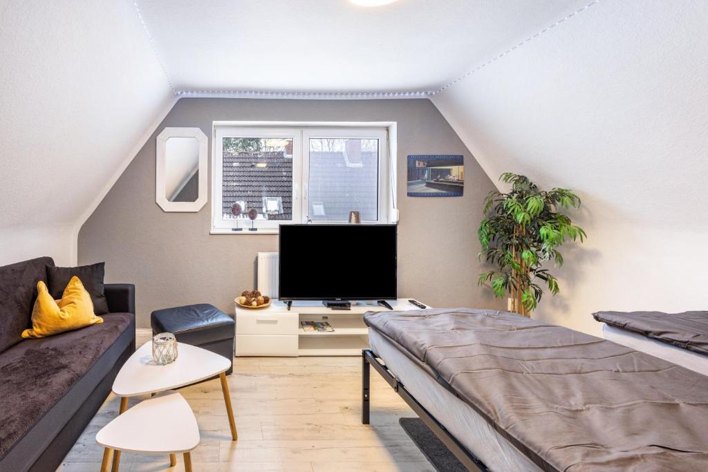 a living room with a couch and a tv at Haus Falk in Zarpen