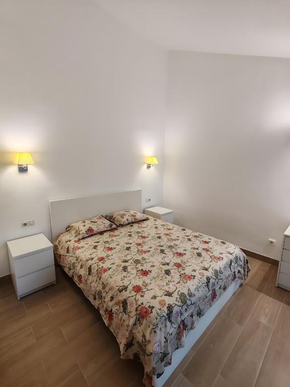 a bedroom with a bed and two night stands at Villa Maria Maspalomas Gran Canaria in Maspalomas