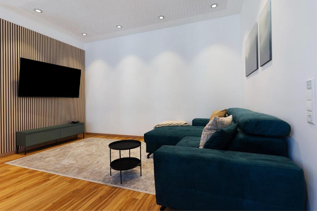 a living room with a couch and a tv at Breisgau Lofts - Nähe Europapark in Herbolzheim