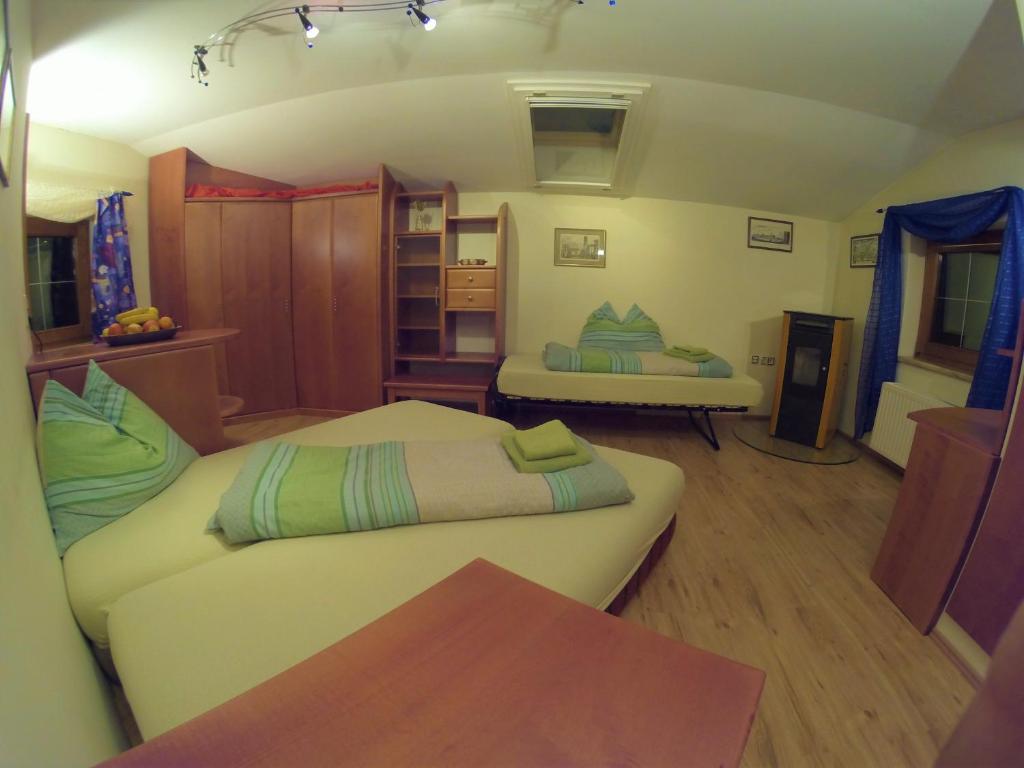 a living room with two beds and a table at Landhaus Breitenberg in Bad Hofgastein