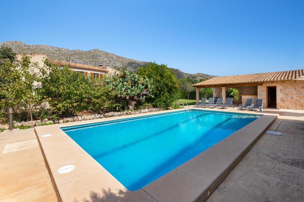 a swimming pool in the backyard of a house at Can noble den suau in Pollença