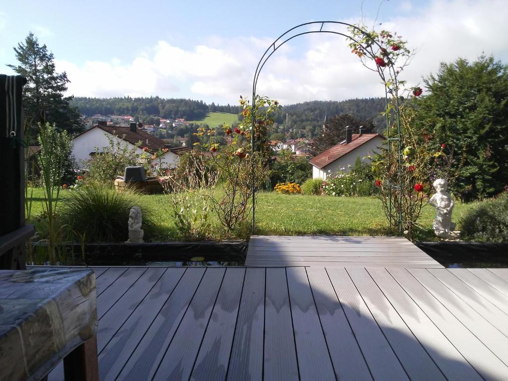a wooden deck with a view of a garden at Ferienwohnung Anita Benz in Thurmansbang