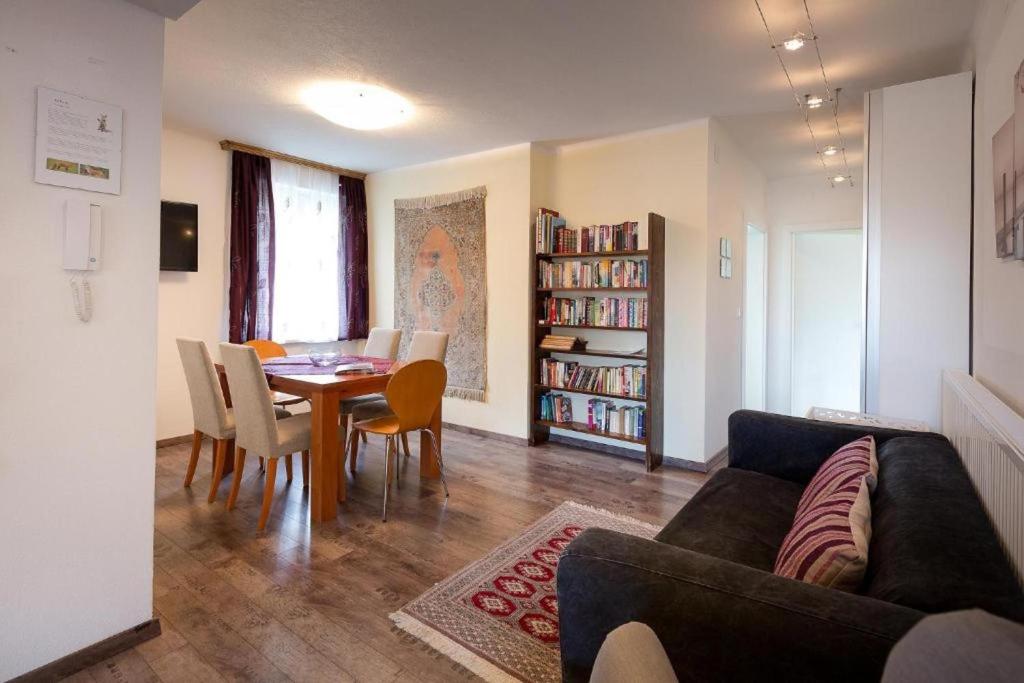a living room with a couch and a table and chairs at Villa Müller Rotfuchs in Ossiach