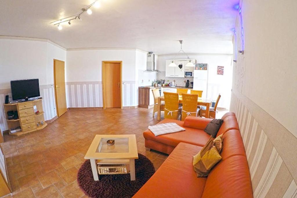 a living room with a couch and a table at Ferienbauernhof - Ferienwohnung 5 in Grünow