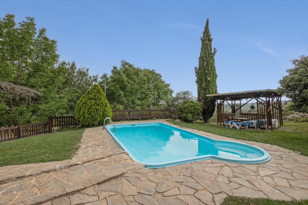 a swimming pool in a yard with a gazebo at Les Cases in Sagás