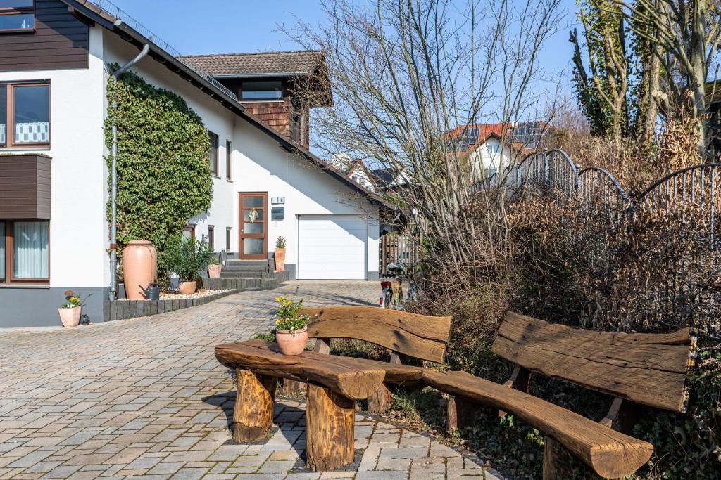 two wooden benches sitting on a brick patio at Fewo Kirchheim in Kirchheim
