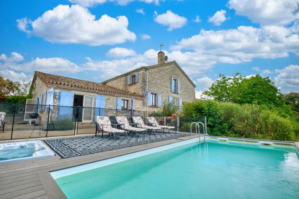 a house with a swimming pool in front of a house at La Maison Roudier in Razac-dʼEymet