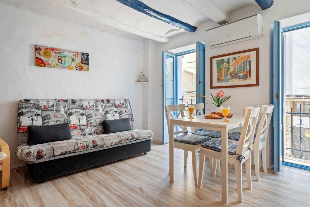 a living room with a table and a couch at Loft Sf5 in L'Ametlla de Mar