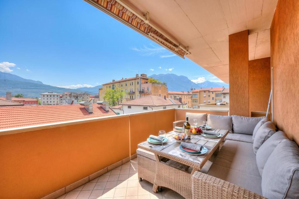a room with a couch and a table on a balcony at Casa Alexander - Lake Garda Apartment with Terrace - Happy Rentals in Riva del Garda