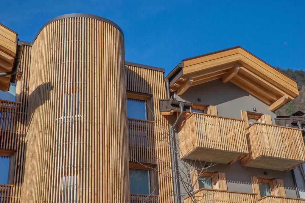 a building with wooden balconies on the side of it at Palazzo Righi in Carisolo