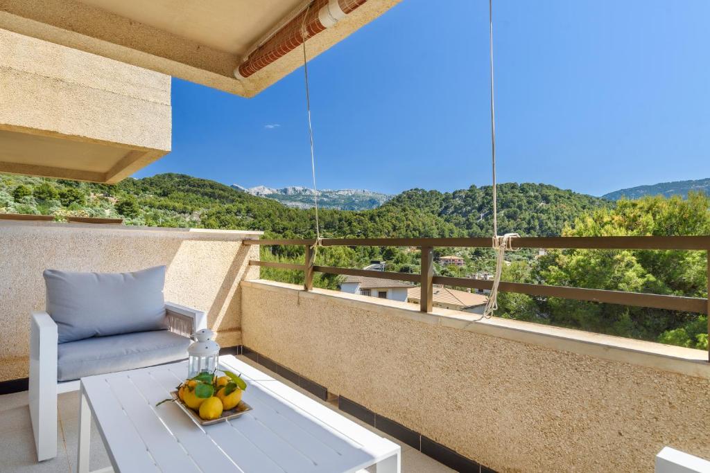 a balcony with a table and a bowl of fruit at Puerto Rico Apt. Port de Sóller in Port de Soller