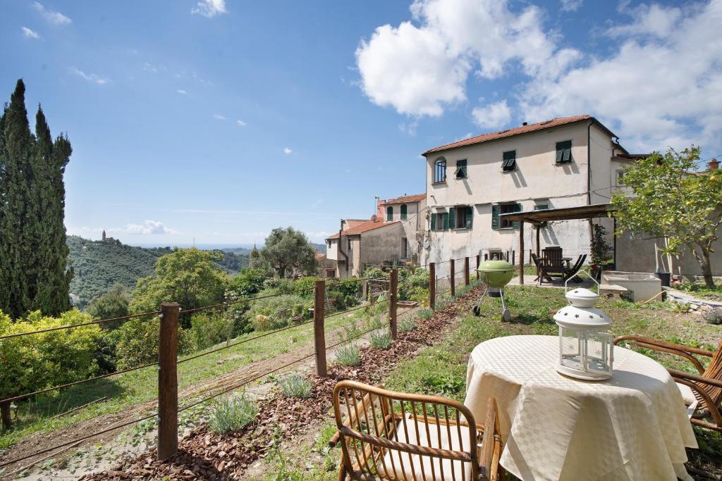a table with a white table cloth on top of a house at Modern Heritage House in Imperia