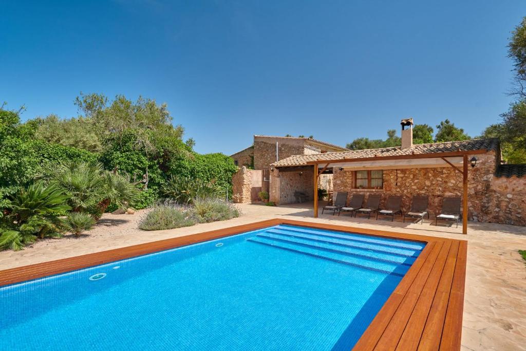 a swimming pool in front of a house at Son Soler - Can Torres in Islas Baleares