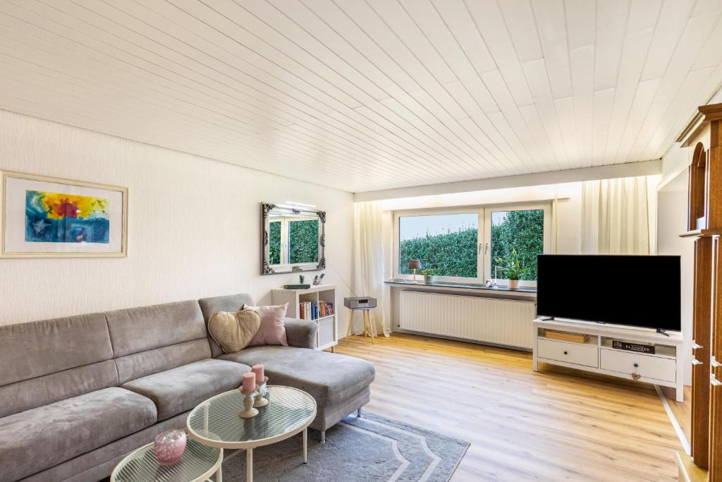 a living room with a couch and a flat screen tv at Haus im Igelweg in Bad Münstereifel