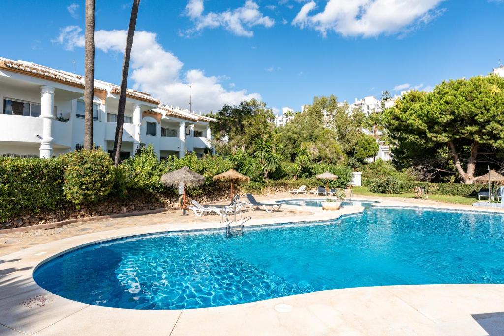 a swimming pool in front of a house at Casa Feliz in Mijas