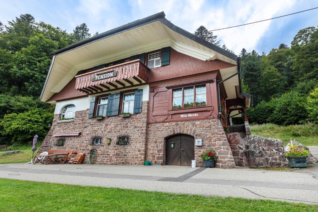 a large brick house with a large window at Pension Alte Gerbe in Außerurberg