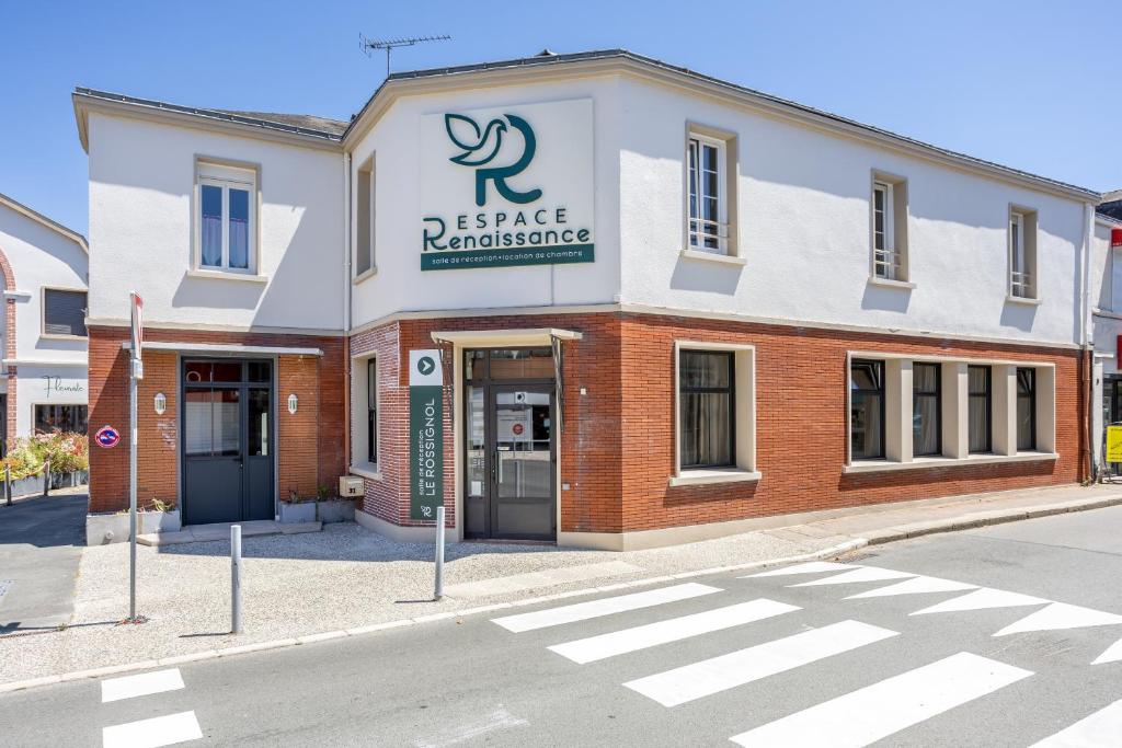 a large brick building with a sign on it at Chambres Espace Rennaissance in Chantonnay