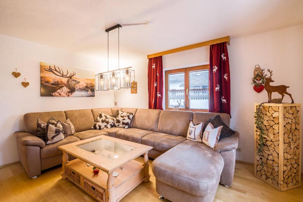 a living room with a couch and a table at Ferienhaus Annelies in Übersee