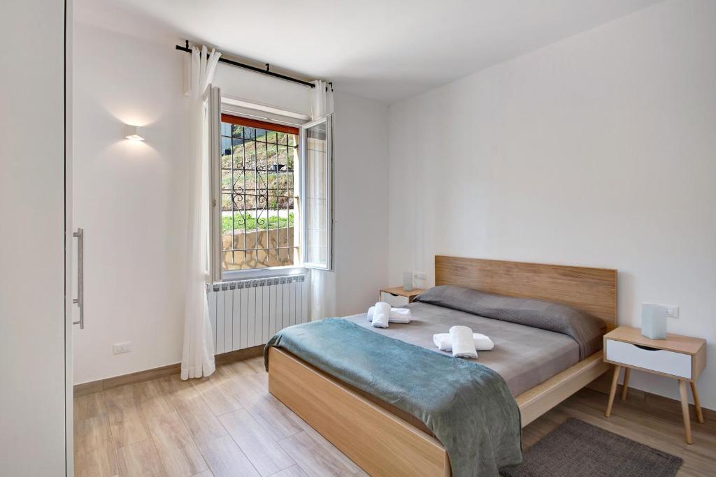 a bedroom with a bed and a window at Moneglia Monte in Moneglia