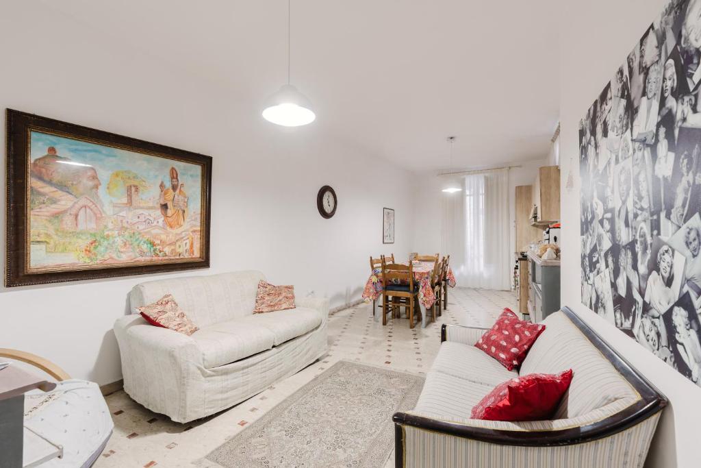 a living room with a couch and a table at Beneath The Castle - Apartment in Corleone