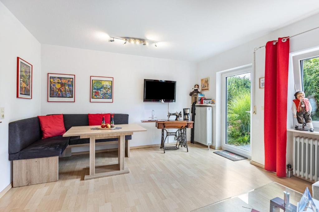 a living room with a couch and a table at Ferienwohnung Schwarzwaldhirsch in Unterkirnach