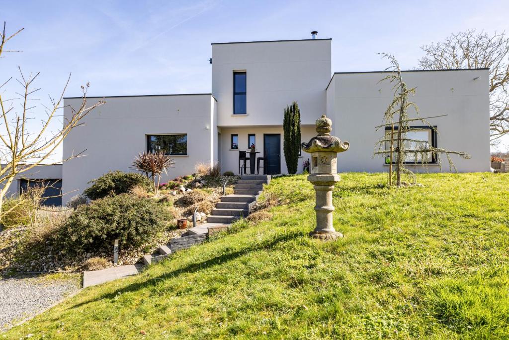 a house with a fire hydrant in front of it at Un Thé sur la Loire in Ballan-Miré