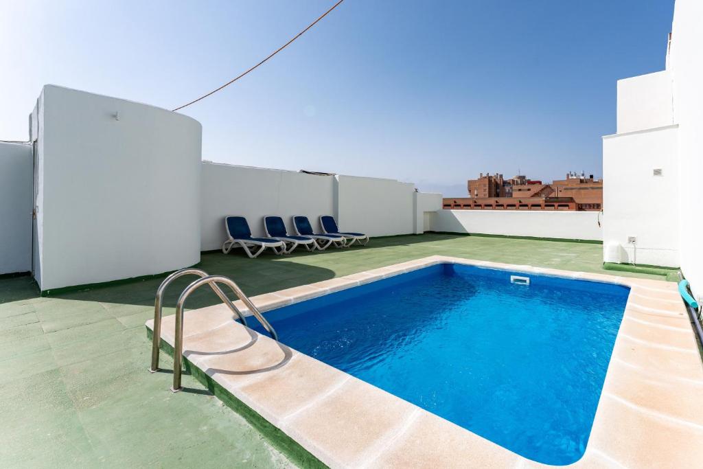 a swimming pool on the roof of a building at Penthouse with private pool in Málaga