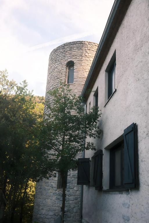 a building with a clock tower on the side of it at Le Saint Marquan in Brantes