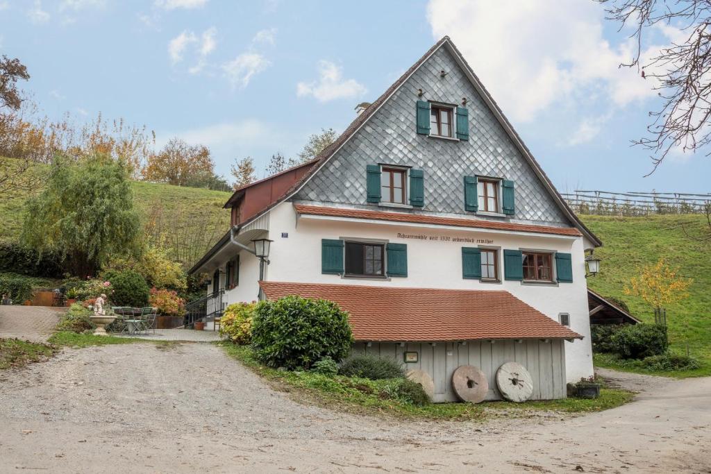 a large white house with a gambrel roof at Ferienwohnung Achraintal 4 in Lindau