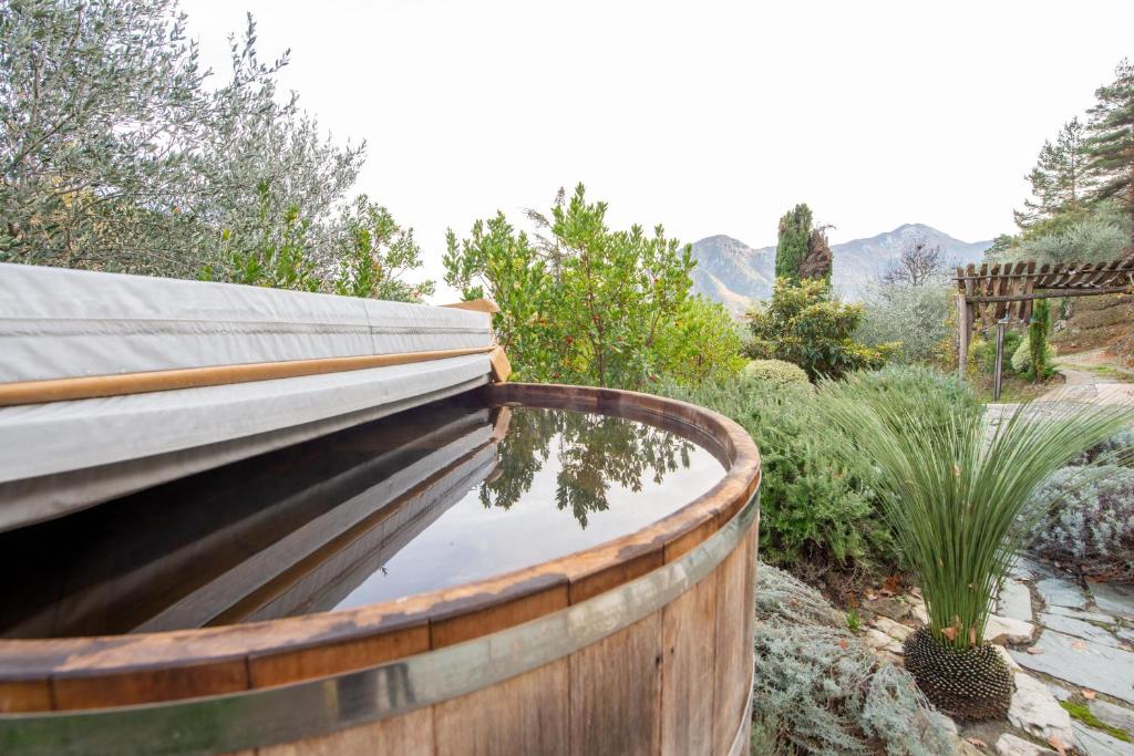 a wooden pool of water in a garden at Eco Chalet - Terrasses et sauna in Sospel