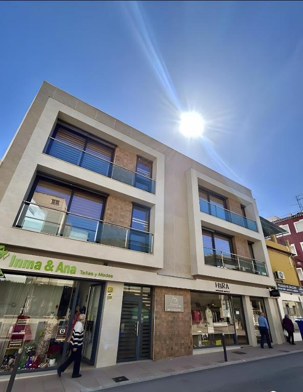 a man walking in front of a building at Edificio Type I in Puente Genil